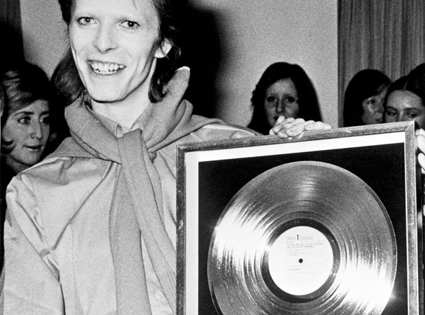 David Bowie holding a Gold Disc