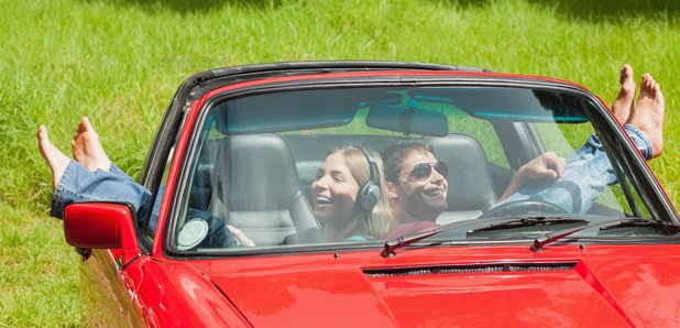 Young couple listening to music in a car