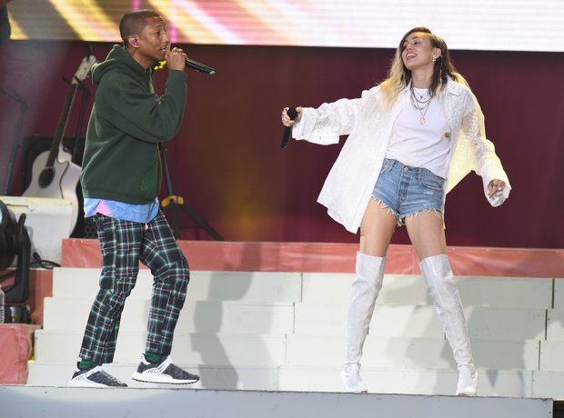 Pharrell Williams and Miley Cyrus live during One