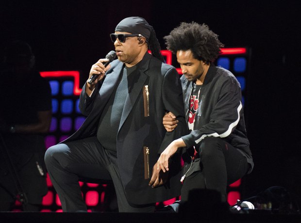 Stevie Wonder kneeling