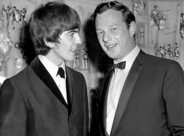 George Harrison talking to manager Brian Epstein