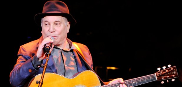 Paul Simon performing on stage