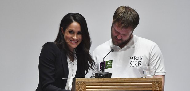 Meghan Markle helps with the award presentation as