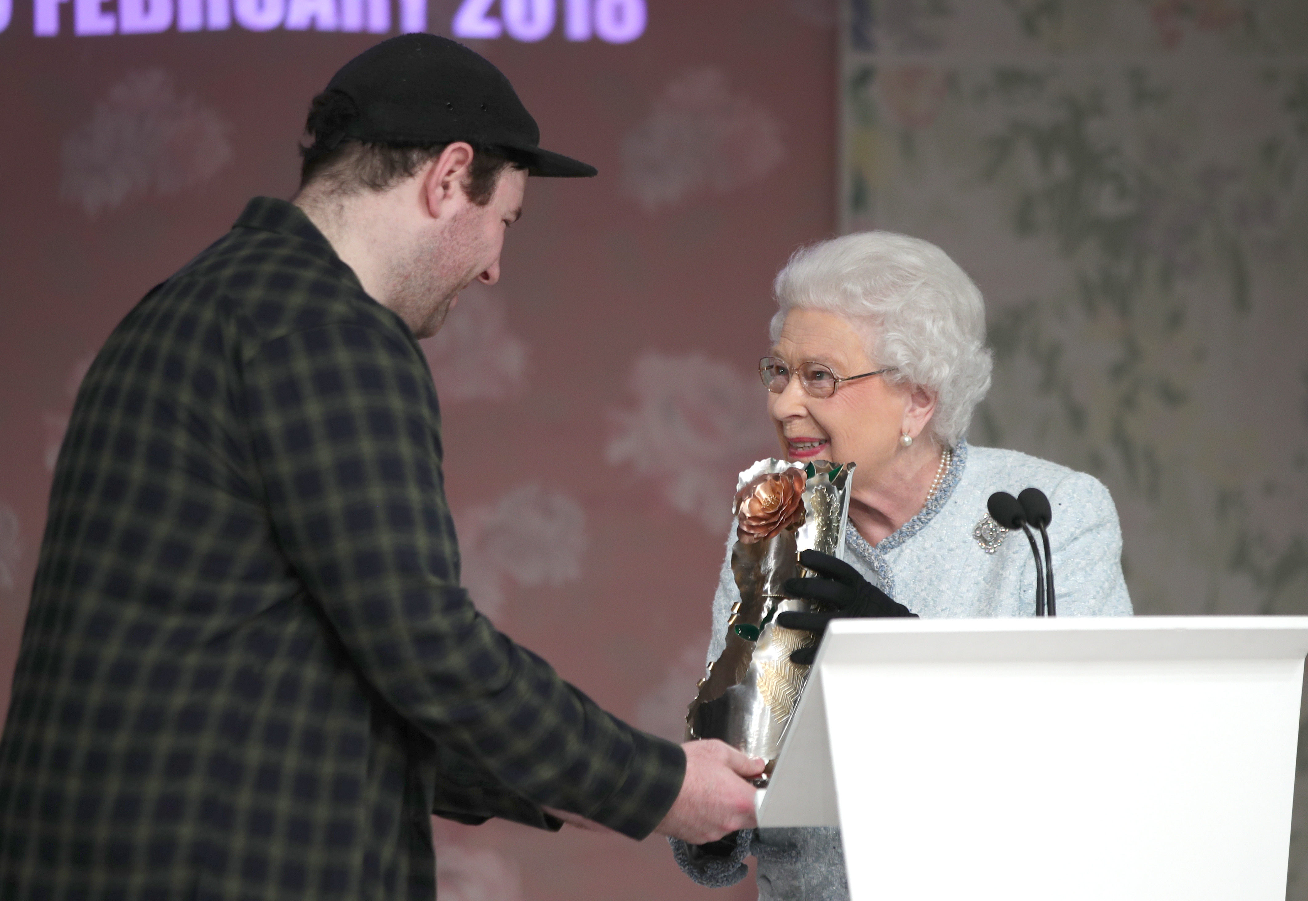 The Queen hands award to Richard Quinn