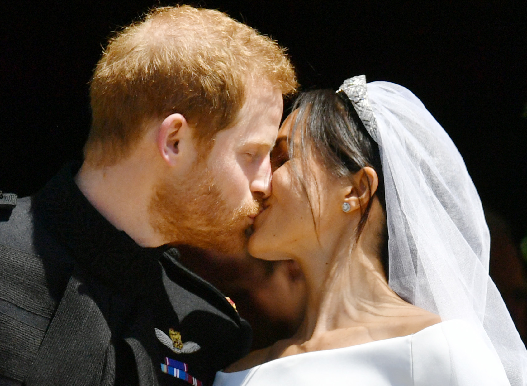 Prince Harry and Meghan Markle kiss on the steps o