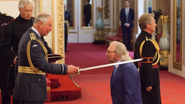 Barry Gibb receives his knighthood from Prince Cha